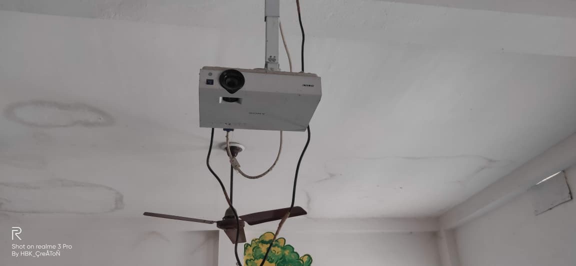 A ceiling-mounted projector in a smart classroom