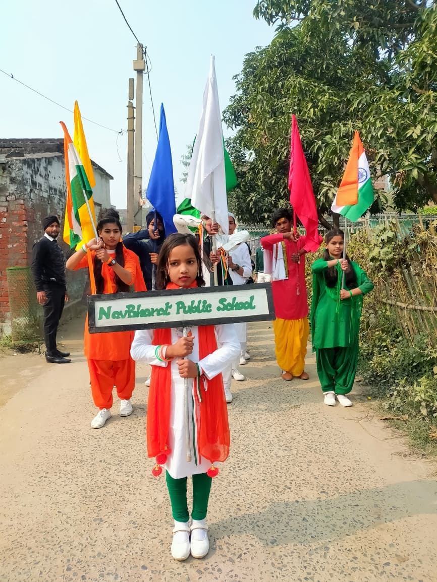 Students leading a Republic Day flag march with tricolour banners